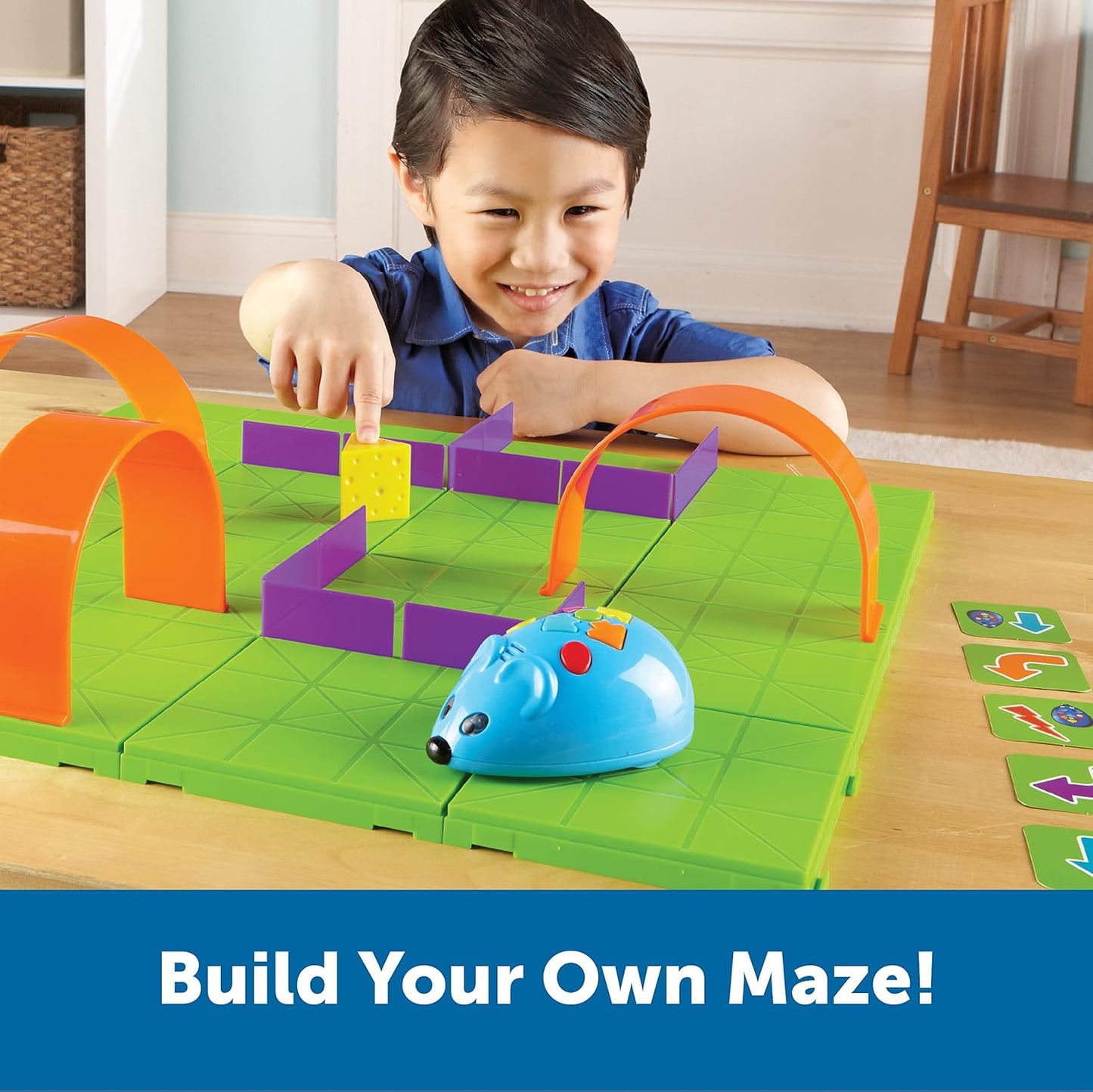 Young boy playing with the Learning Resources Rechargeable Code & Go Robot Mouse, building his own maze. Screen-free STEM learning for ages 4+, teaching coding through hands-on play.