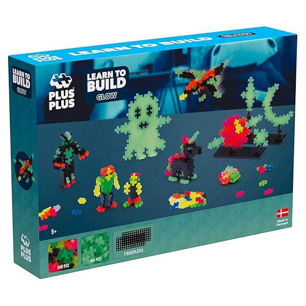 The Plus-Plus Learn to Build Glow-in-the-Dark box, featuring 500 interlocking pieces for creative building. The packaging highlights glowing models and STEM benefits.
