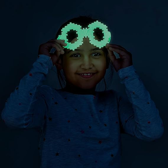 Child wearing plus-plus glow in the dark glasses - creativity gone wild!
