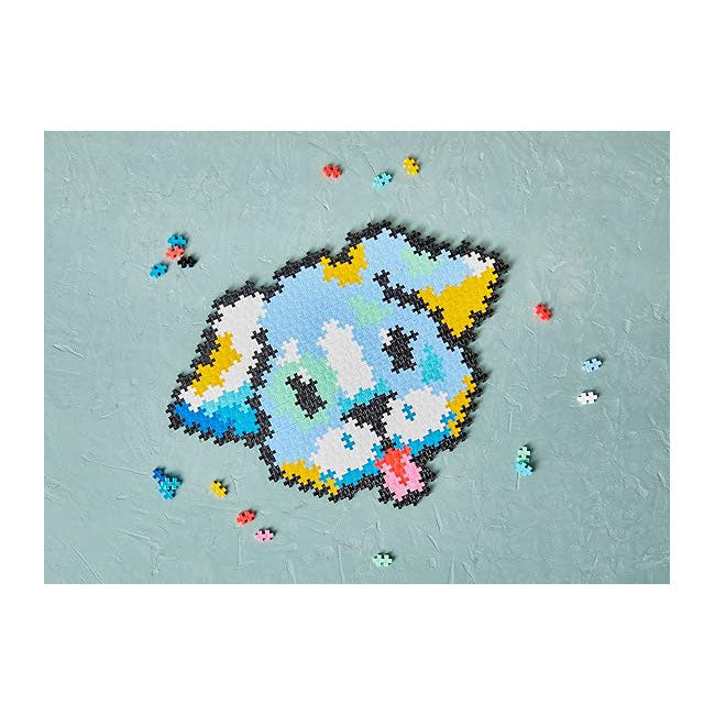A completed Plus-Plus Puzzle By Number Puppy model, built from 500 colorful interlocking pieces, with a few pieces scattered.