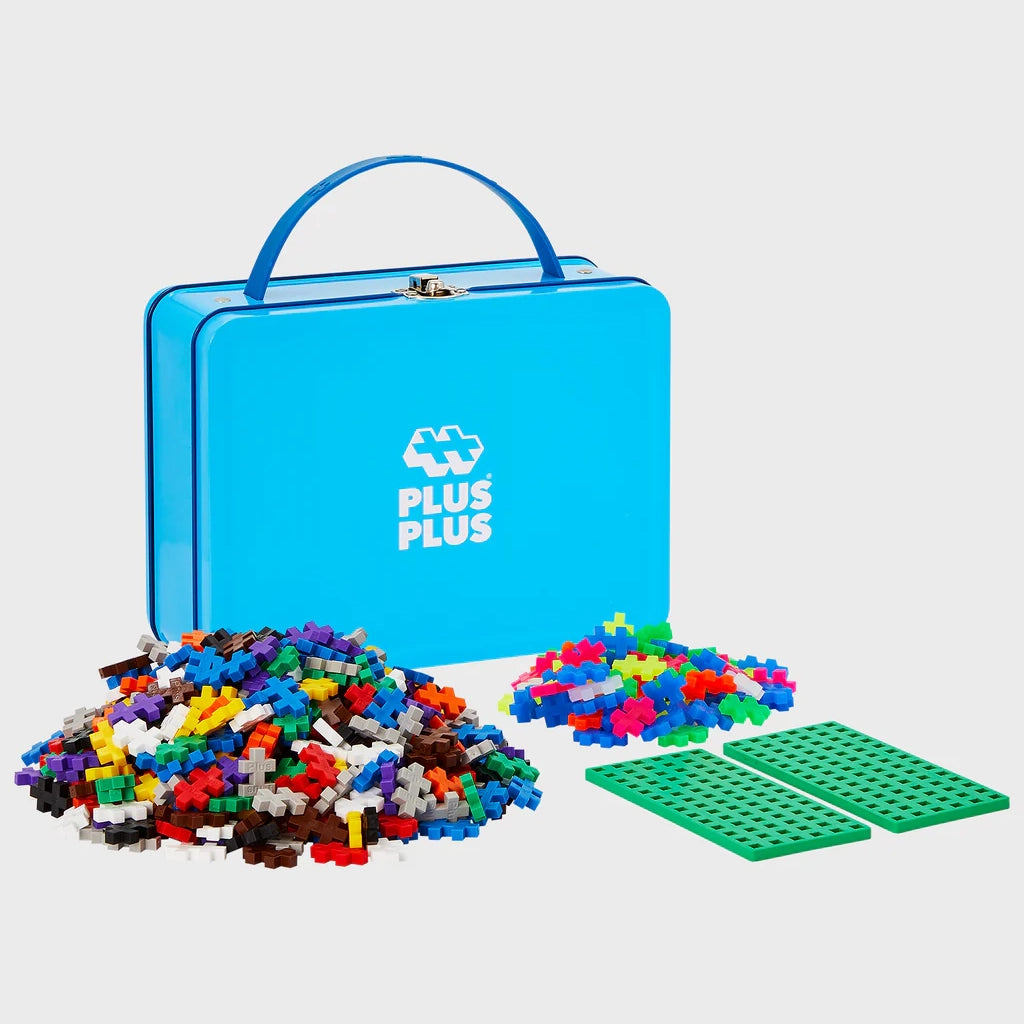A blue Plus-Plus Metal Suitcase containing 600 colourful interlocking pieces, designed for creative building on the go. The sturdy tin keeps pieces secure.