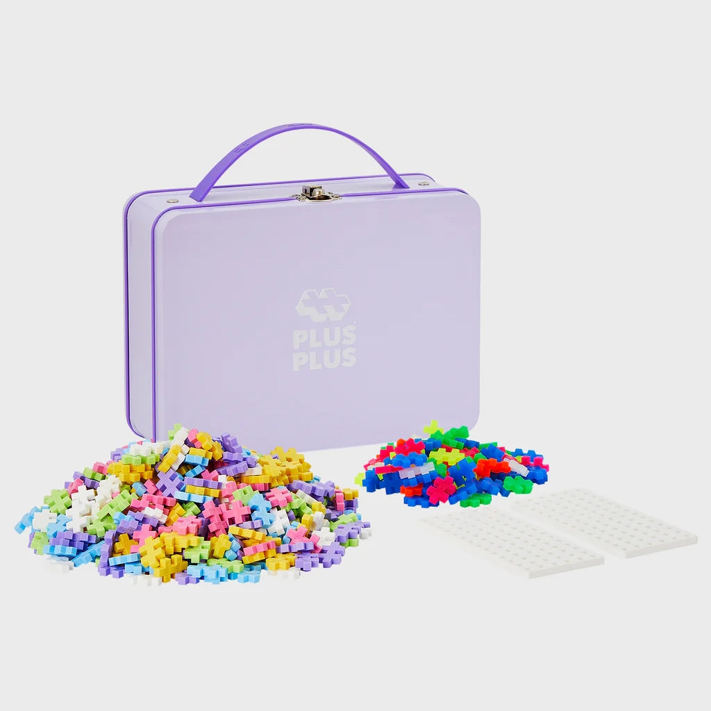 A durable purple Plus-Plus metal suitcase containing 600 interlocking pieces, designed for creative play and easy transport