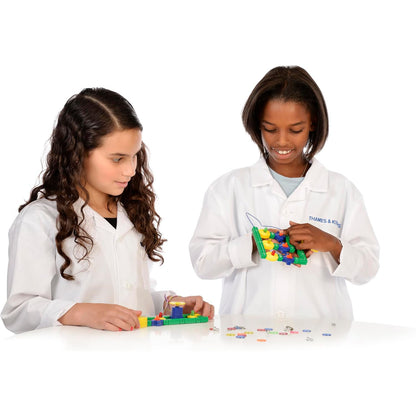 Two children experimenting with the Thames & Kosmos Electricity & Magnetism kit, connecting colorful circuit components to explore electromagnetism and electric currents